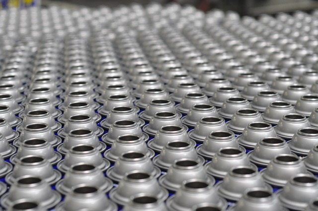 Picture of large numbers of spray cans on automated assembly line