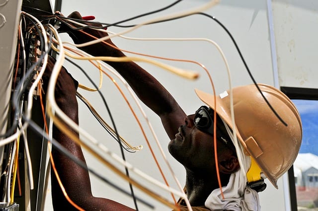 Electrical Technician Checking Wire Connection