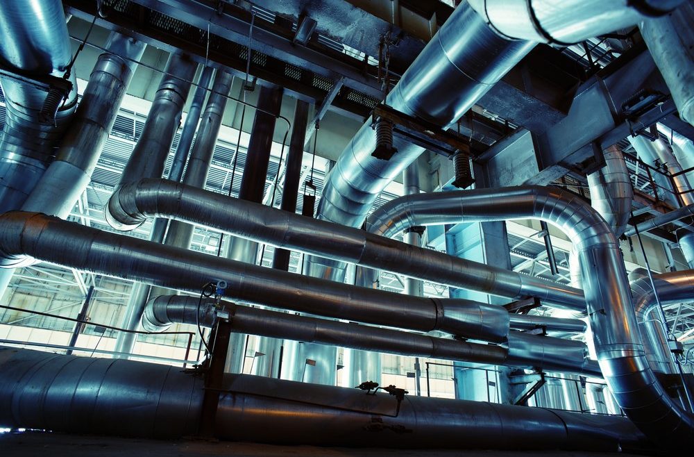 Equipment, cables and piping as found inside of a industrial power plant