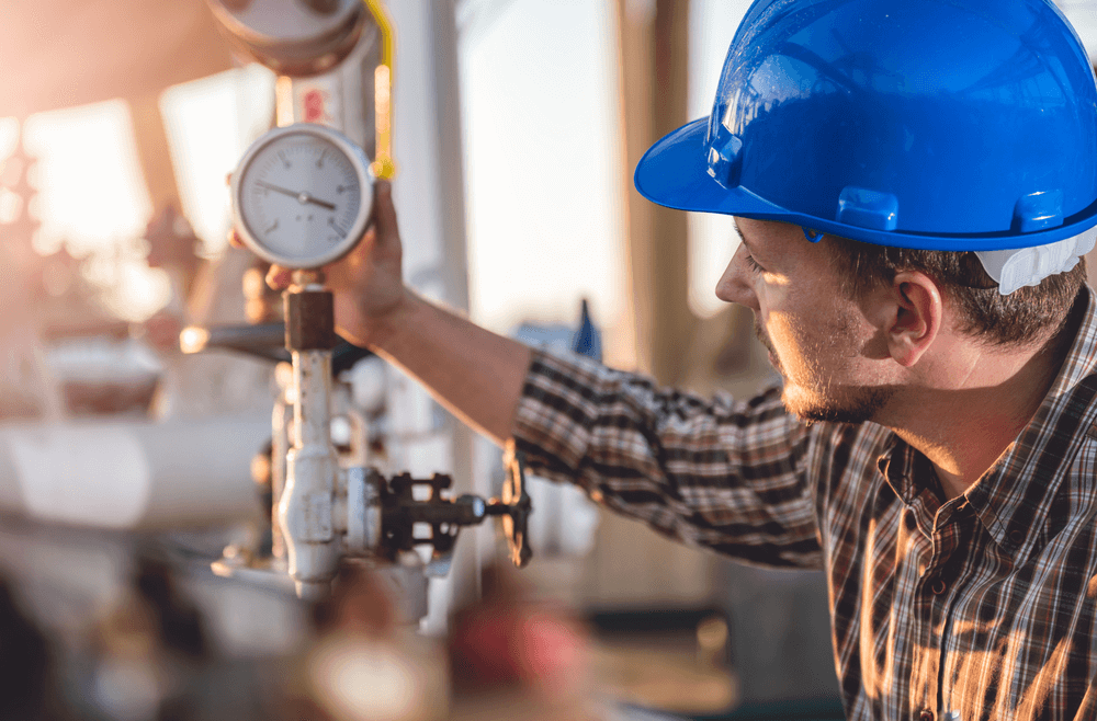 Man checking manometer in natural gas factory