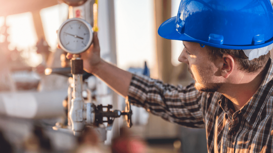 Man checking manometer in natural gas factory